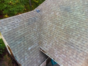 a trusted East Hartford roofer inspects a roof for summer storm damage