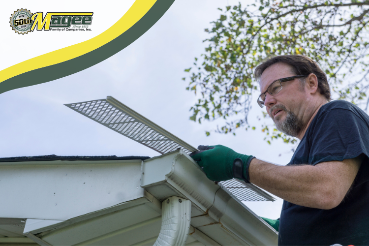 Close-up of a Unionville roofer cleaning a gutter to prevent winter roof damage