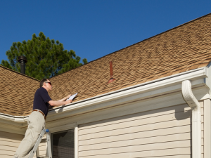 A professional conducting a Farmington roof repair inspection