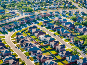 Aerial view of a residential neighborhood in Farmington showing a variety of roofs, highlighting different roofing styles and conditions