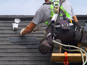 Close-up of roof repair in West Hartford, showing damaged shingles