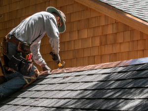 Professional roofer performing roof repair in New Britain